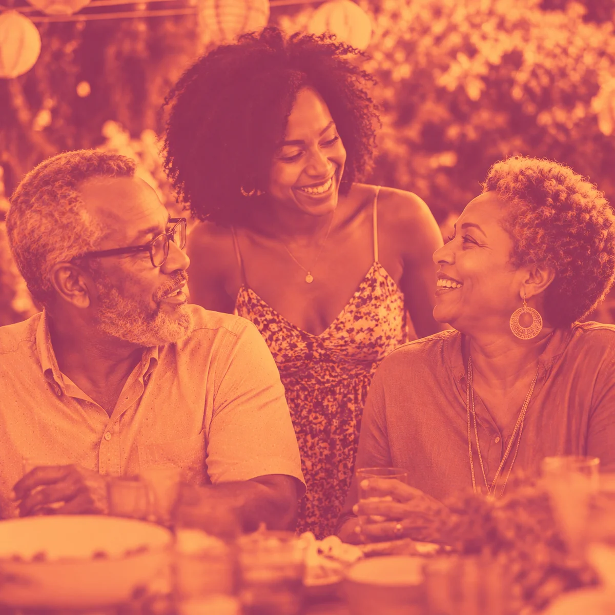Warm duotone photograph of three people of different ages at a casual outdoor gathering, warm rose and gold duotone overlay, natural light, relaxed atmosphere