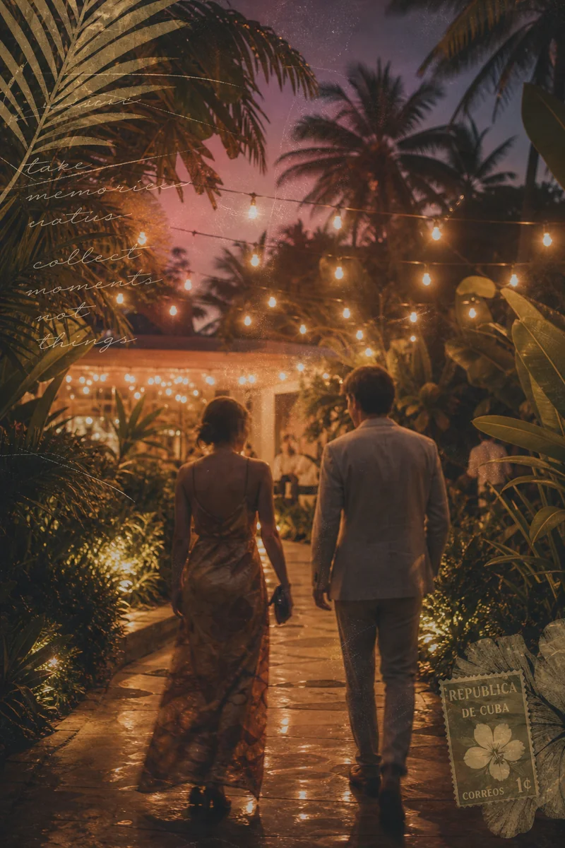 Two people walking a garden path toward an evening venue under string lights