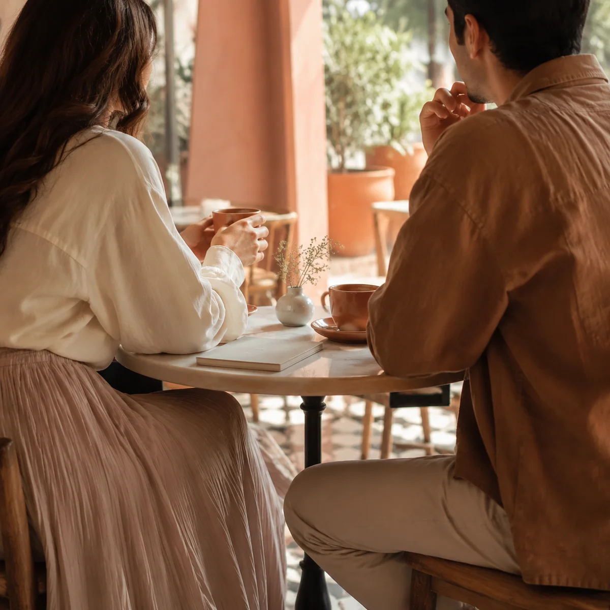 Monogamish couple talking over coffee, editorial photography style
